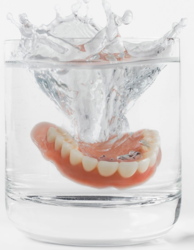 Dental impression on glass of liquid.